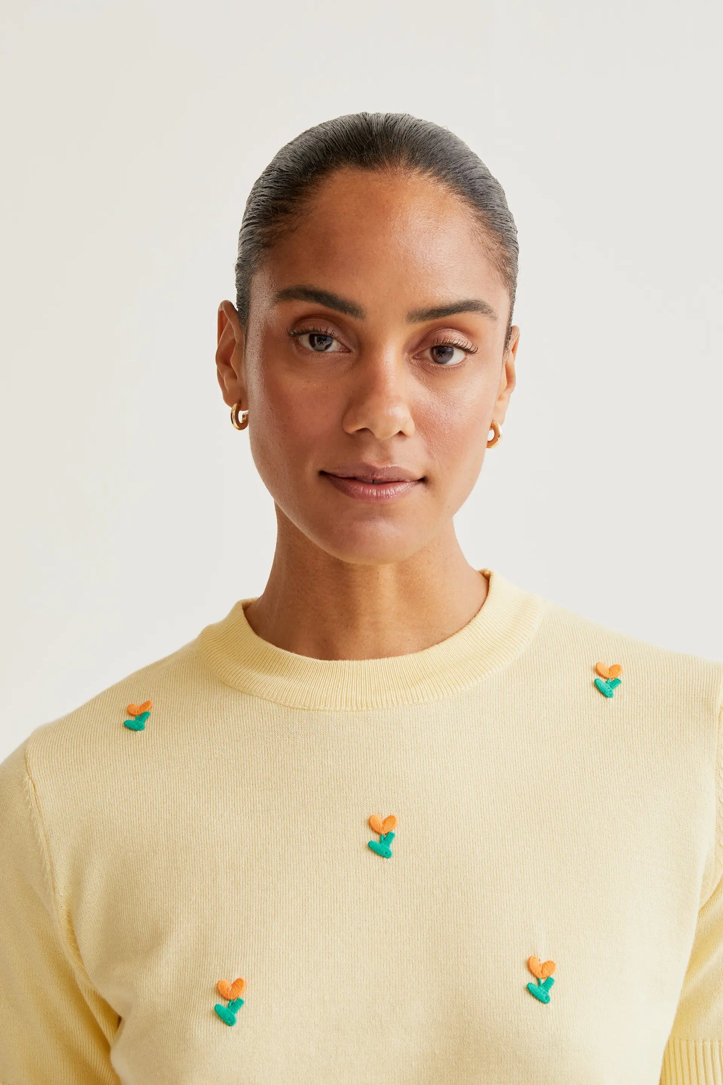 Soft yellow knit top with flowers