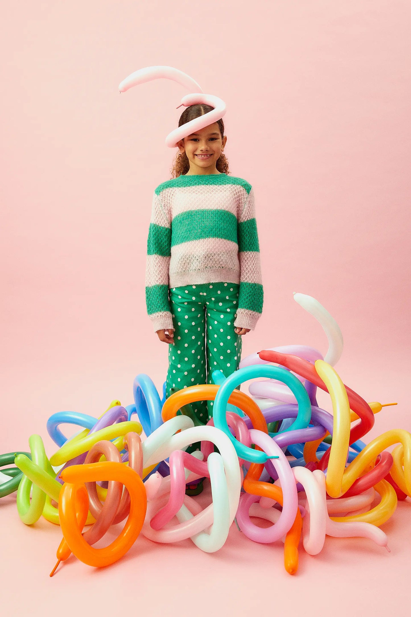Girl's pink striped cable knit sweater