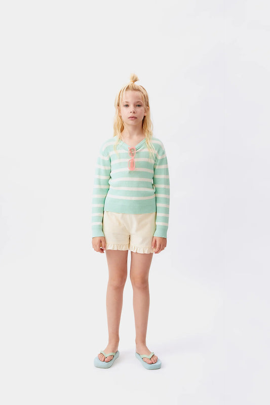 Pantaloncini bianchi con volant da bambina