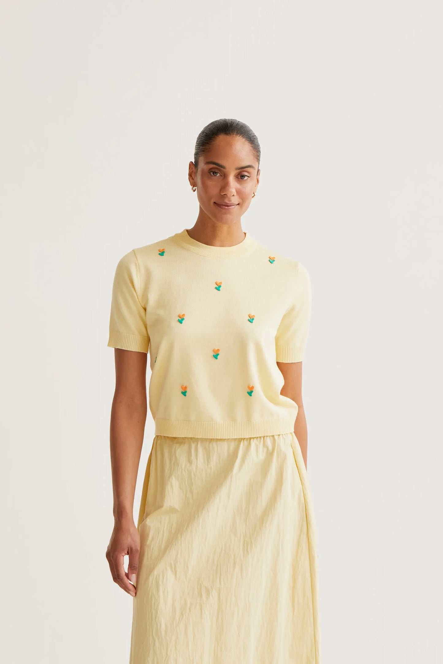 Soft yellow knit top with flowers