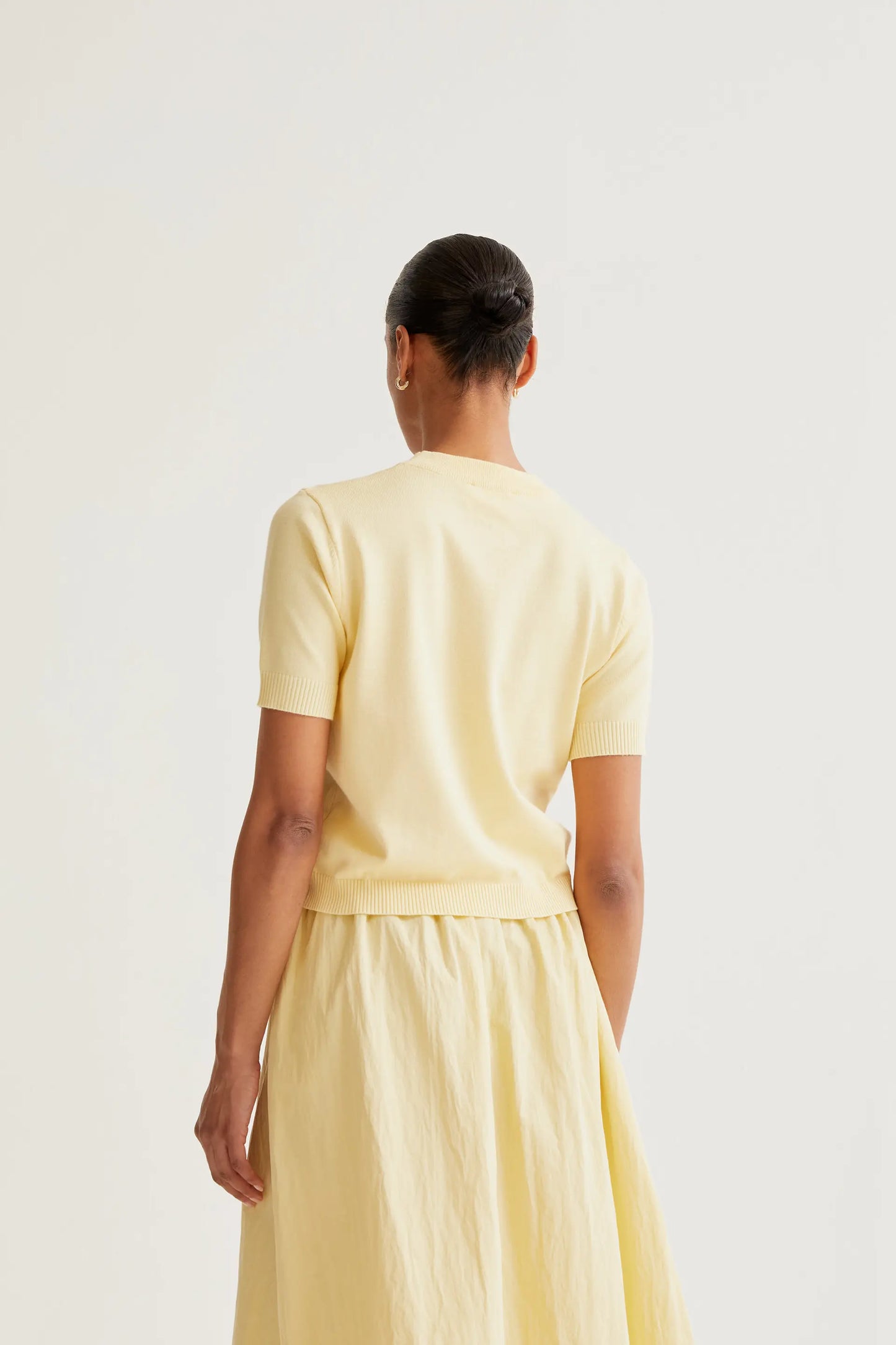 Soft yellow knit top with flowers