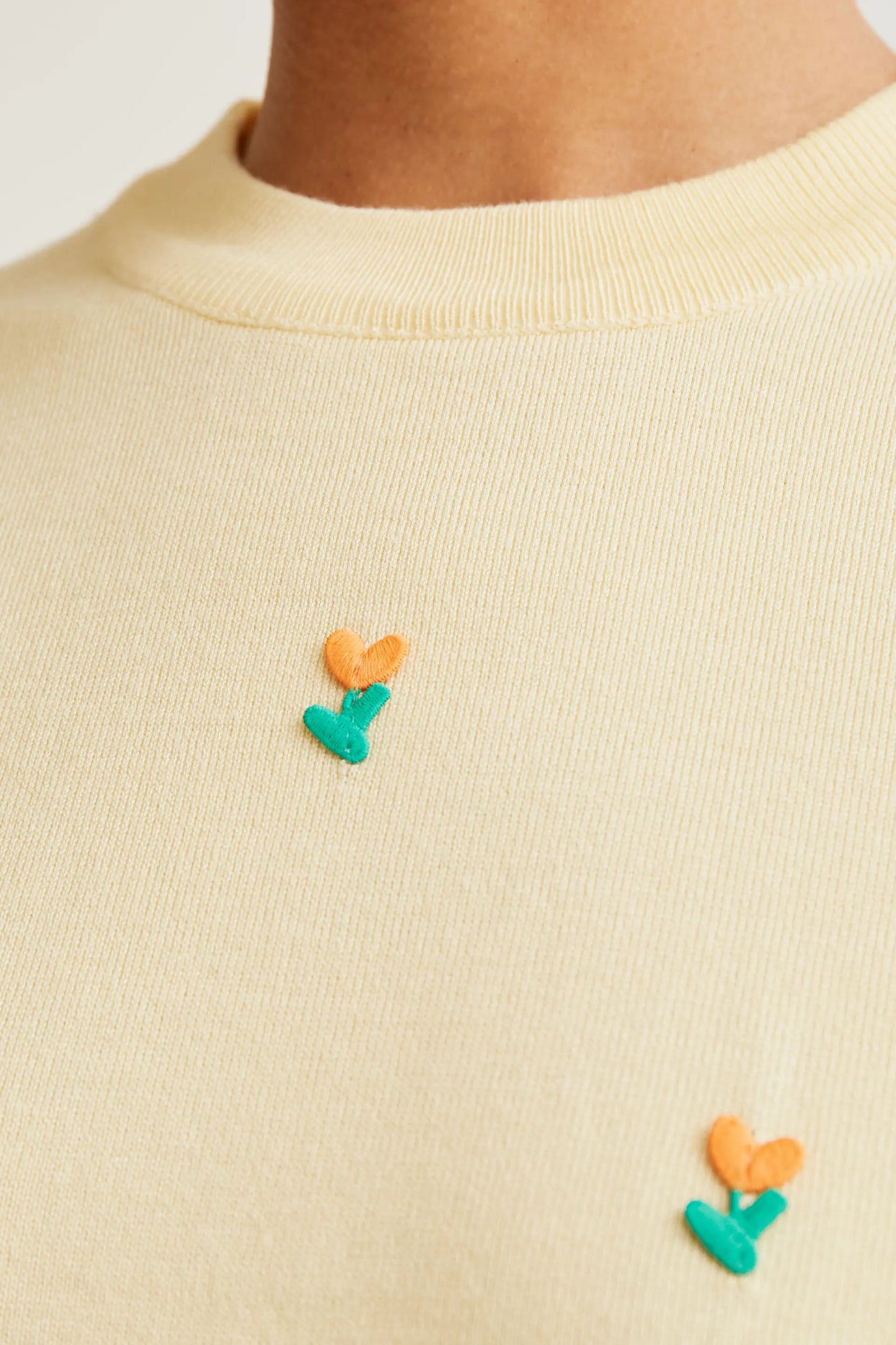Soft yellow knit top with flowers
