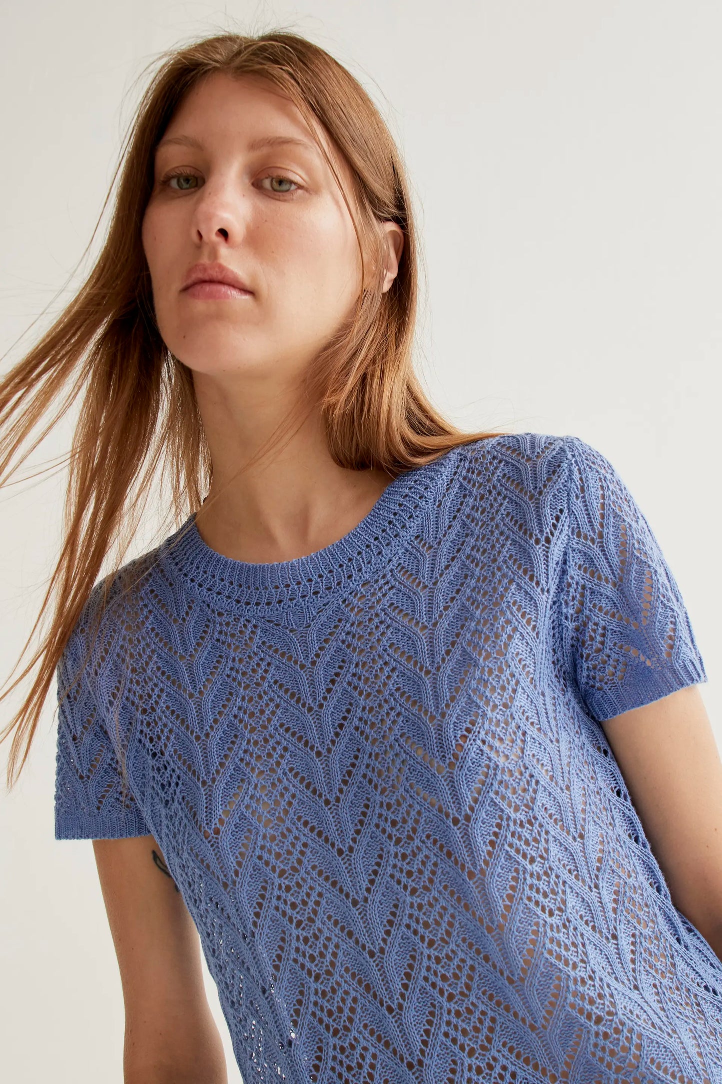 Light blue openwork embroidered top in the shape of a flower