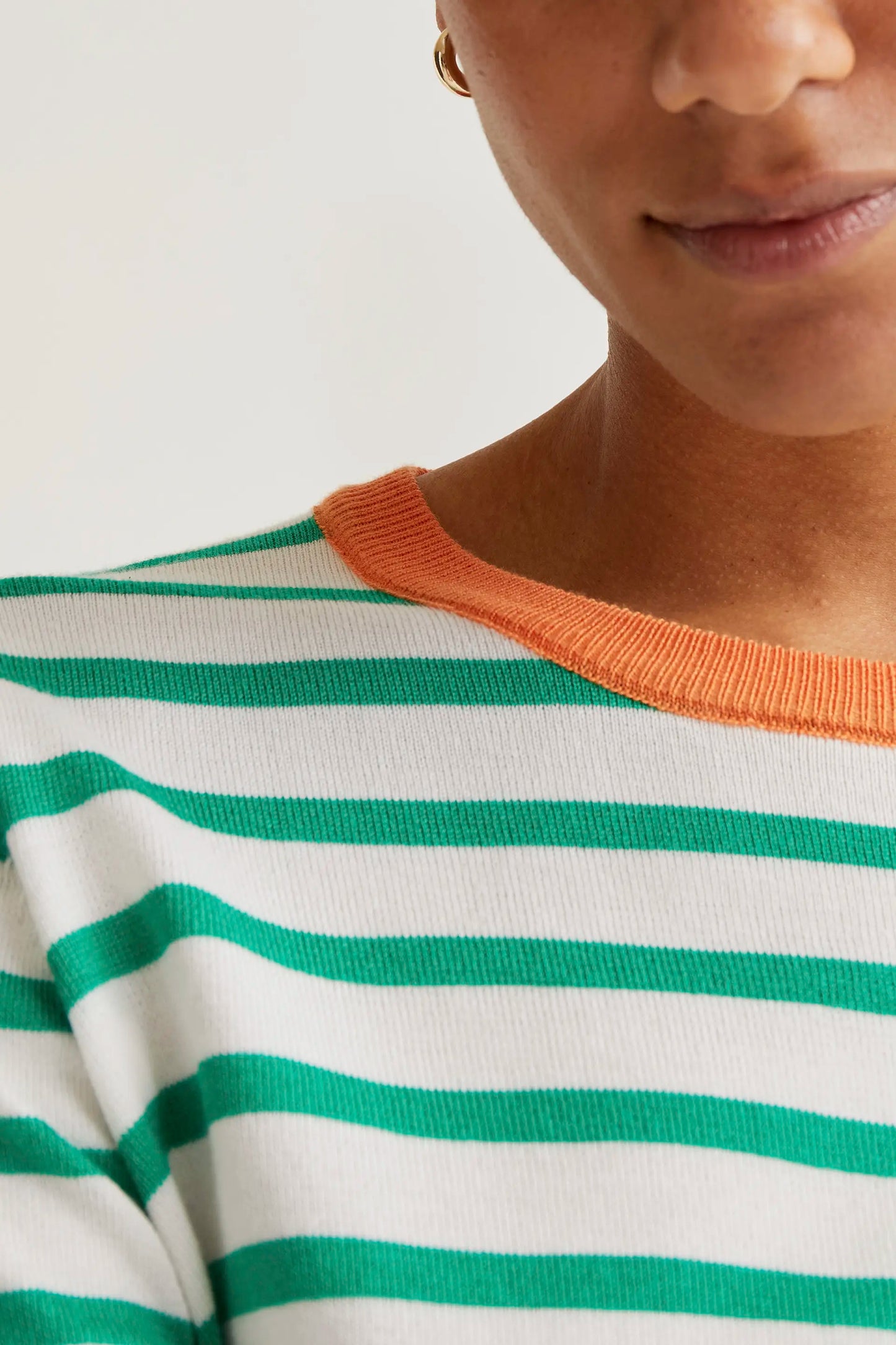 Knitted sweater with white and green striped print