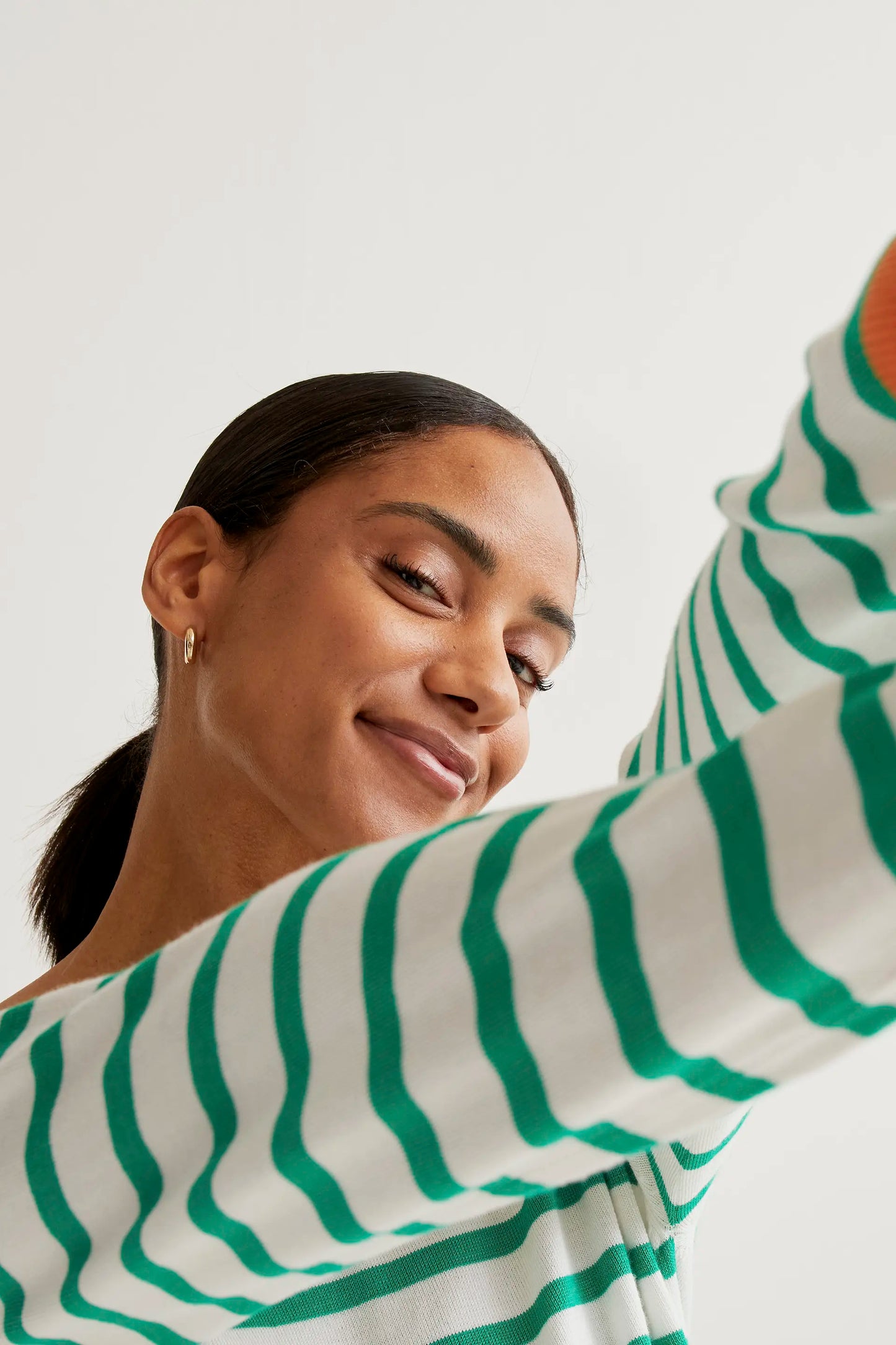 Knitted sweater with white and green striped print