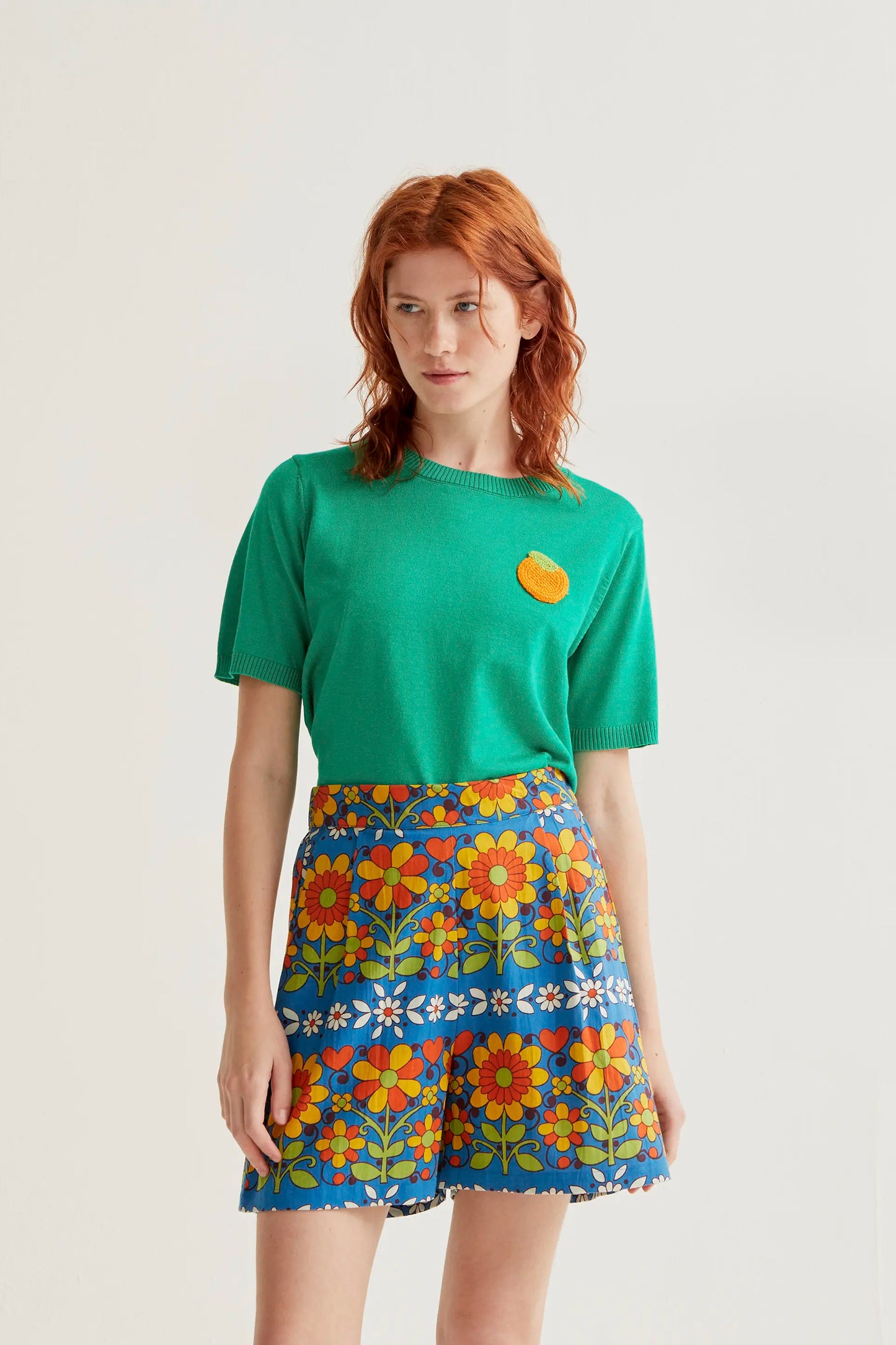Green knit top with orange embroidery