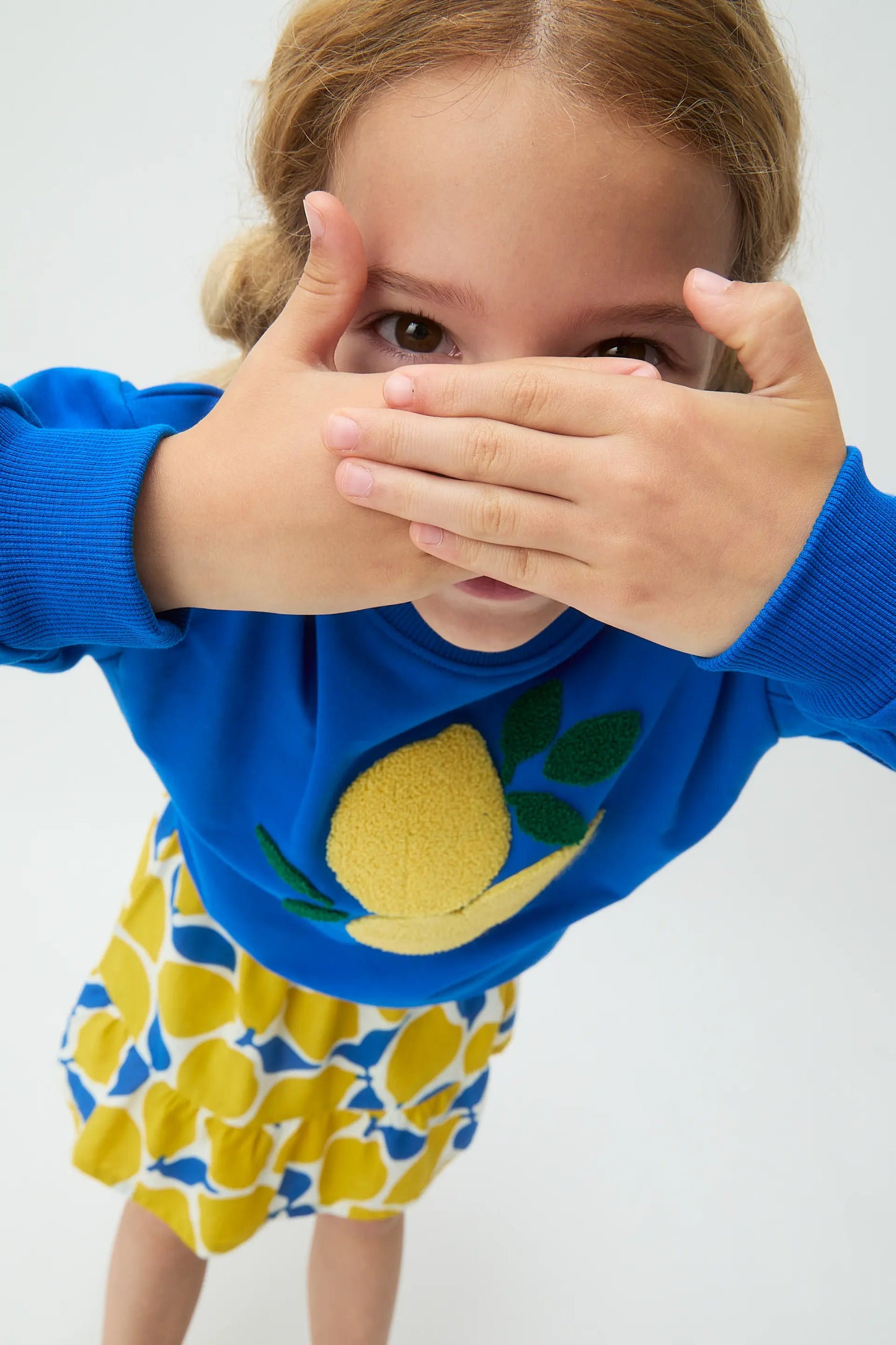 Blue girl's sweatshirt with lemon patch