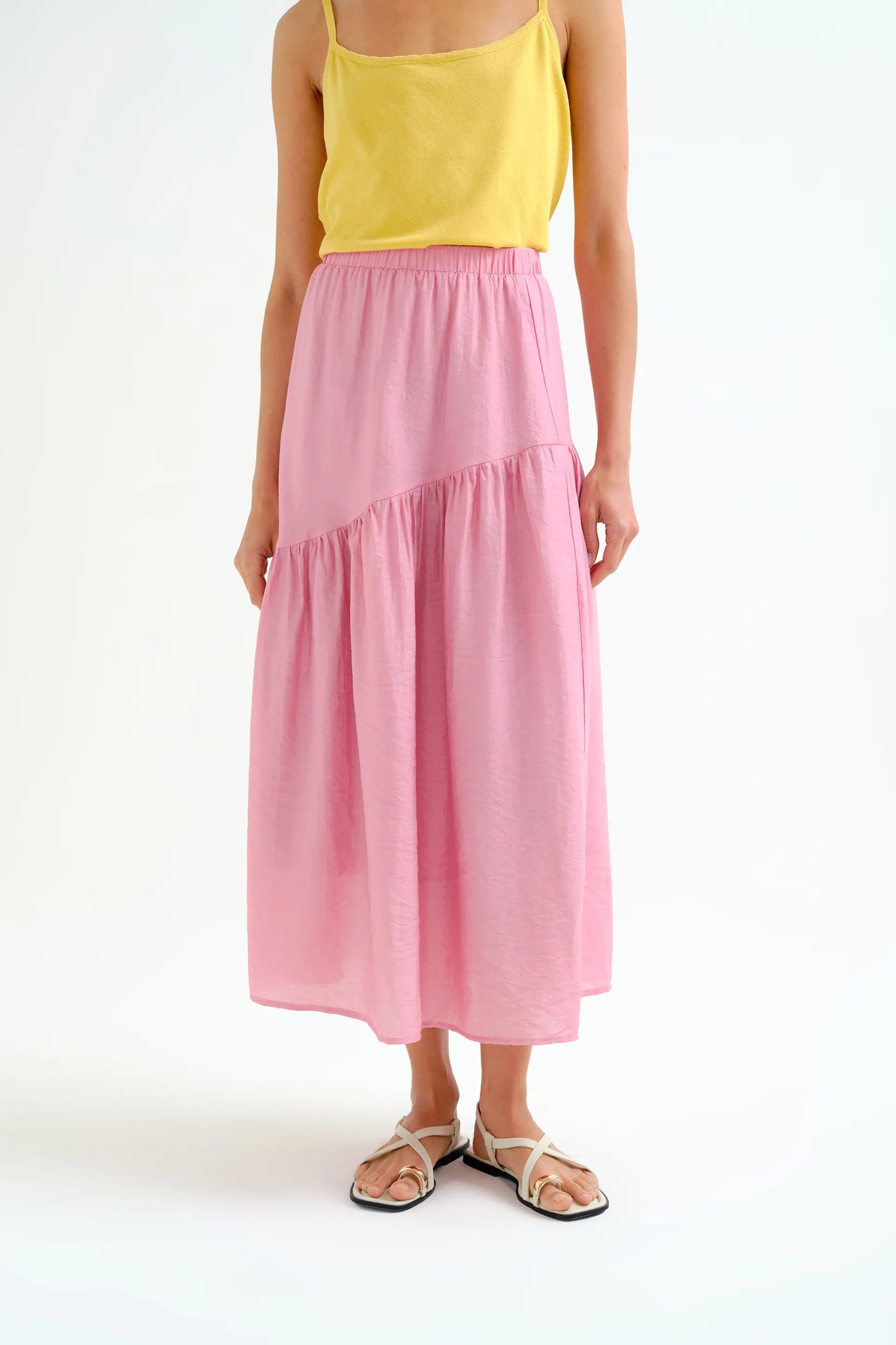 Long pink skirt with an asymmetrical cut
