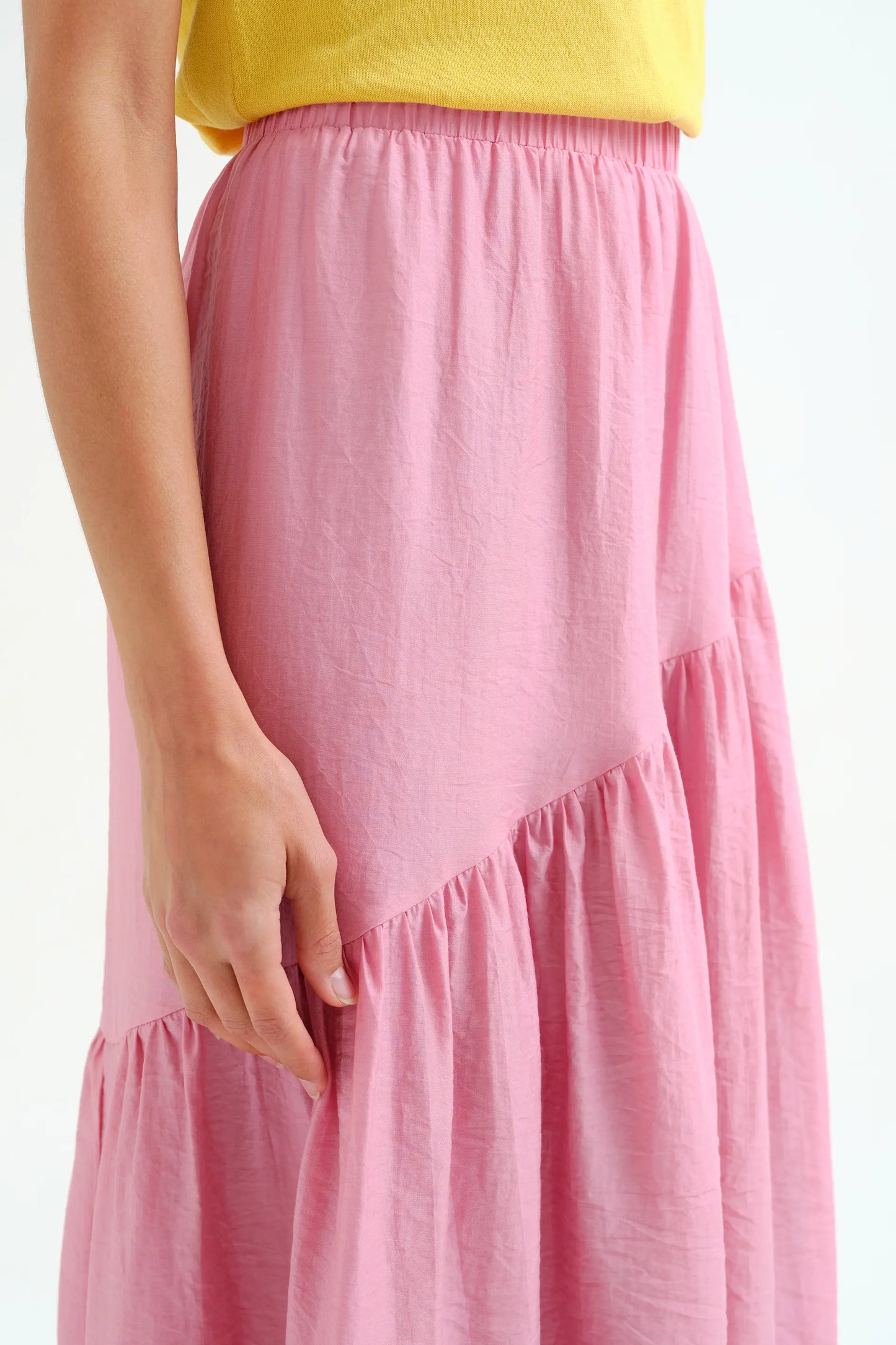 Long pink skirt with an asymmetrical cut