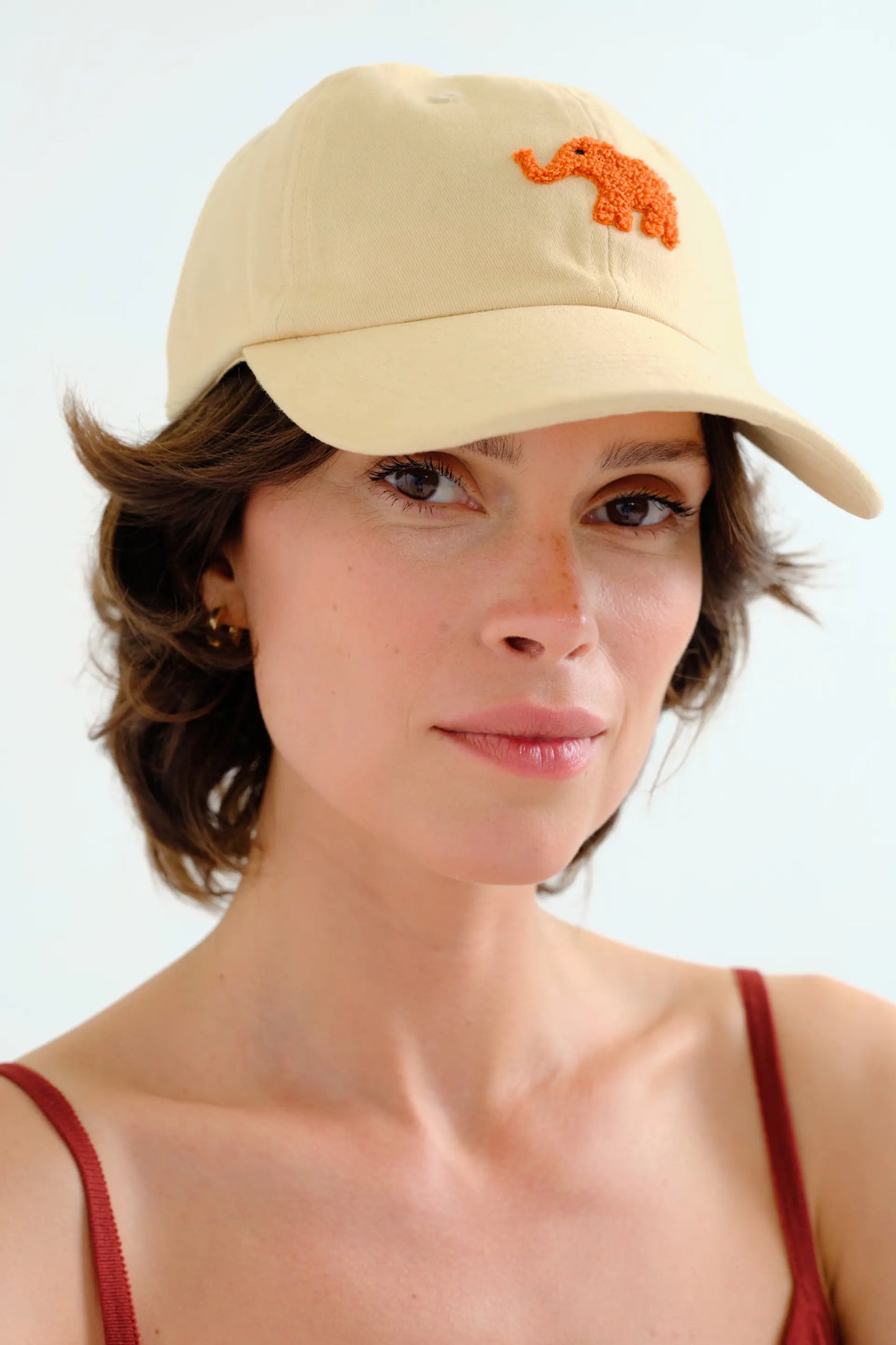 Beige cap with red elephant embroidery